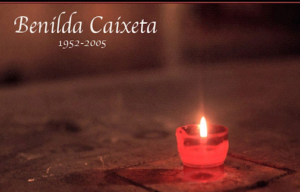  Picture of a small candle. The text above the candle reads "Benilda Caixeta" and "1951-2005."