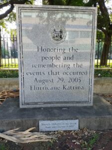 Polished marble memorial outdoors, which says, "Honoring the people and remembering the events that occurred August 29, 2005; Hurricane Katrina."