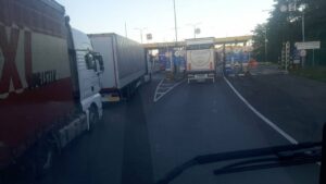 Image of trucks in a line at a border crossing.