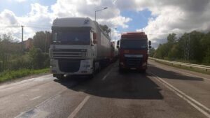 Image of two trucks on the road in Ukraine. 