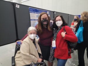 Melissa Marshall from The Partnership sits in her scooter next to colleagues Meg Traci from the University of Montana Rural Institute for Inclusive Communities and JoAnn Thierry from the CDC. All three are wearing masks.