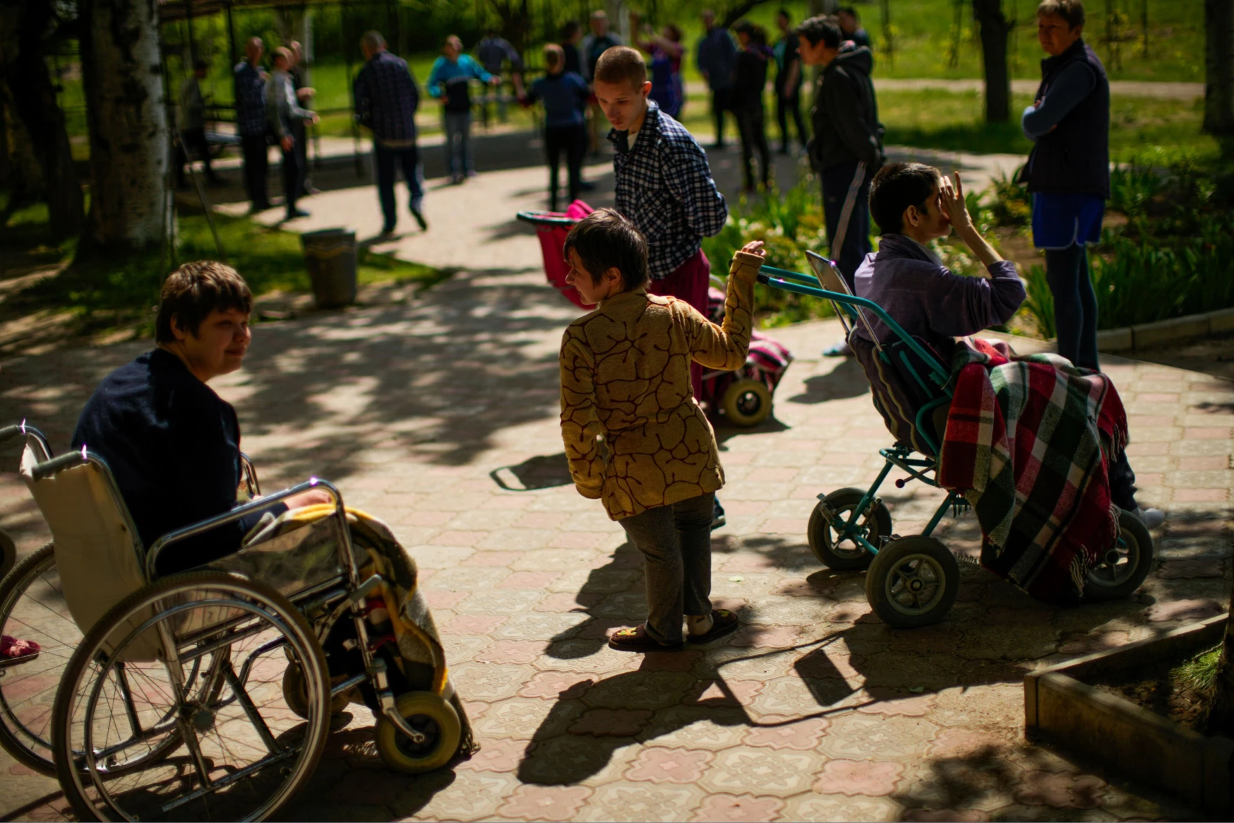 Residents spend time outdoors in a facility for people with mental and physical disabilities in the village of Tavriiske, Ukraine. The staff is faced with the dilemma of evacuating the facility. (Francisco Seco/AP).