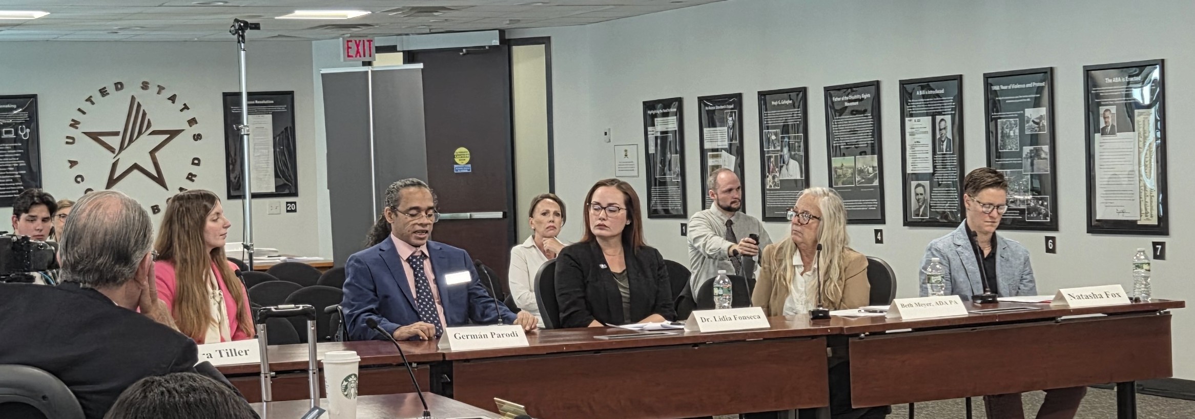 Photo of five people sitting at a table presenting at a meeting. From left to right they are Kira Tiller, Germán Parodi, Lidia Fonseca, Beth Meyer, and Natasha Fox.